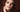 Close-up of a model with a dark smudged smoky eye, illustrating the crypt eyes under-lash makeup trend