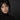 Model wearing deconstructed eyeliner with an upper wing on one eye and lower-lash liner on the other