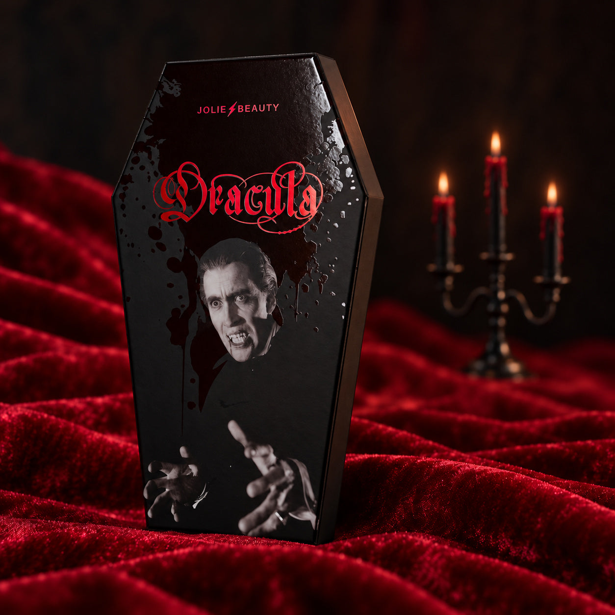 Dracula coffin-shaped palette on red velvet beside candlelight